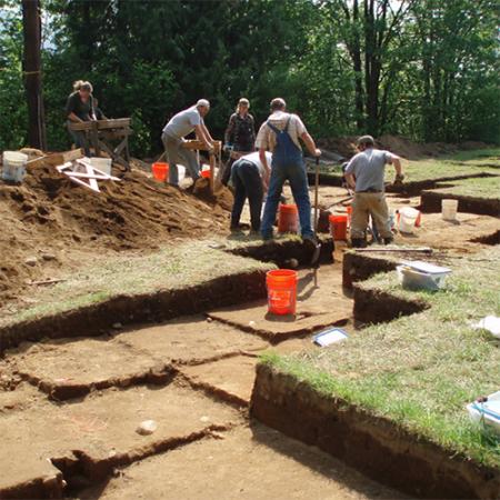 a team of archaeologists work at a dig site