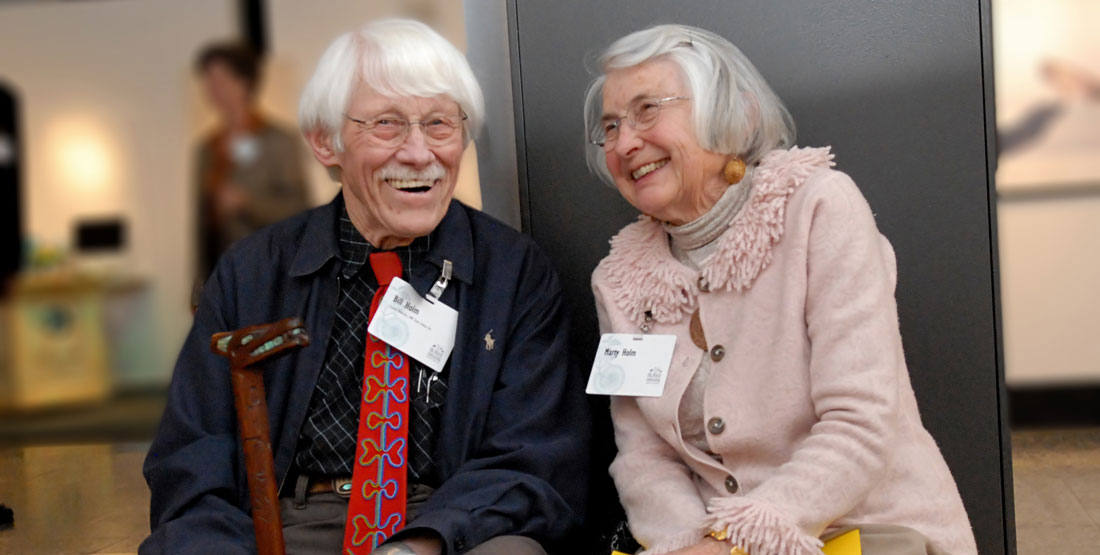 an older couple smile at each other