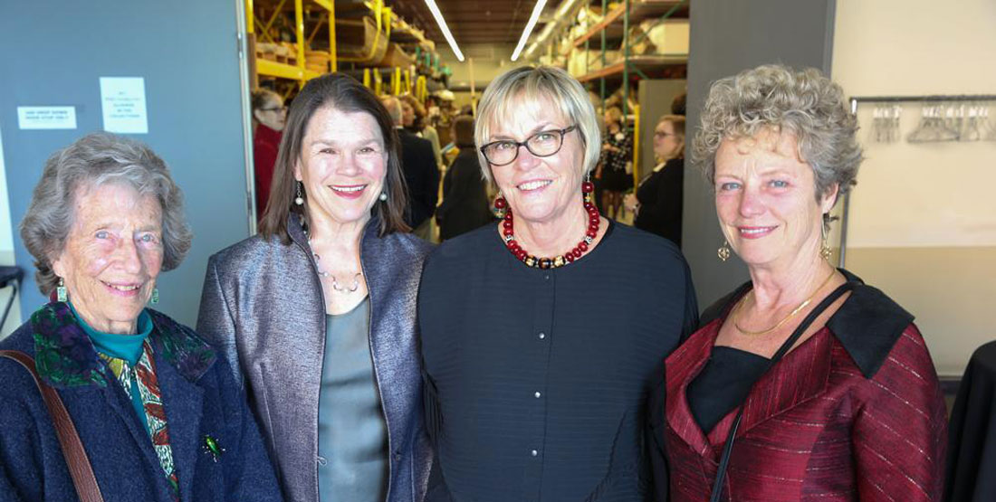 four women pose for a photo outside of the Burke's boat storage