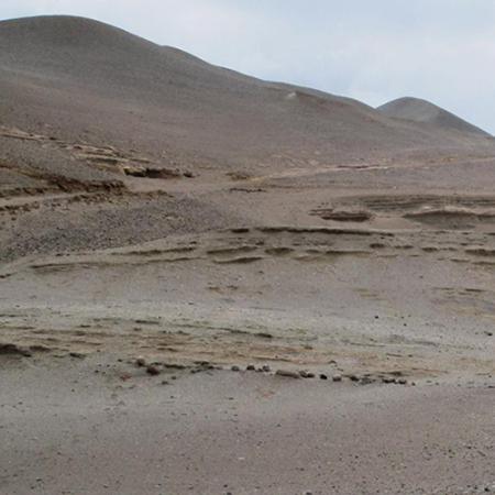 A view of a sandy desert with grey sky