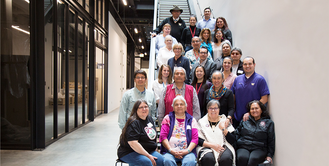 A group of people standing on stairs smiling a the camera