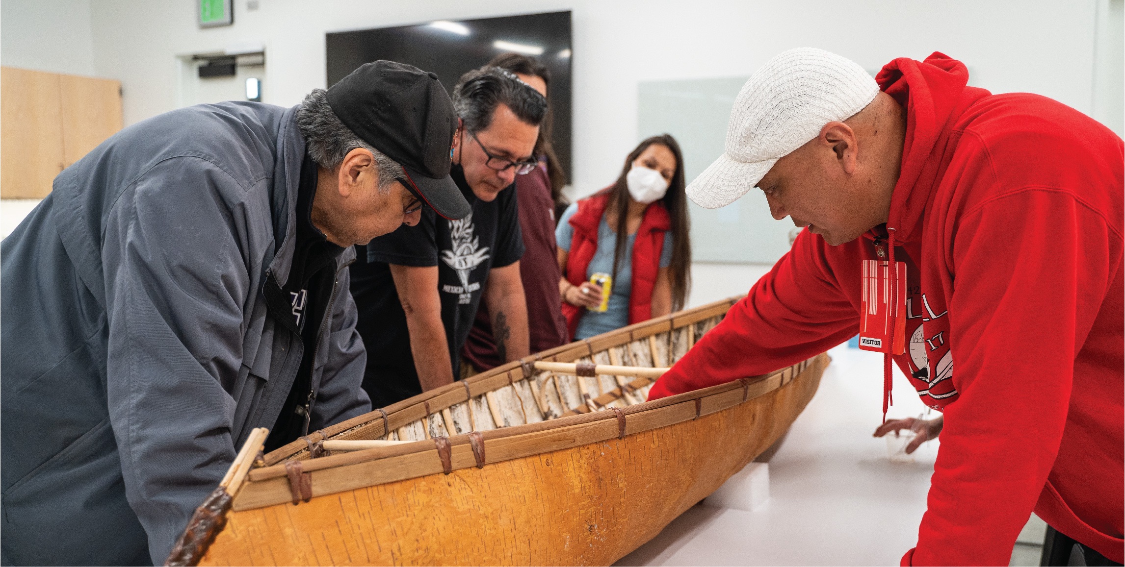 Shawn shows the bitter cherry bark-lashing pattern he used to connect different elements of the canoe together.